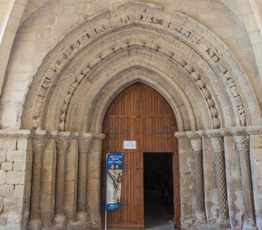 Puente la Reina, Spain - March 30, 2024: Romanesque portal of Church of Crucifijo, Puente La Reina, Navarre, Spain clipart