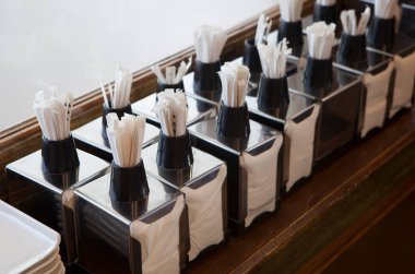 Napkin holders with toothpick dispenser on top. Table service concept clipart