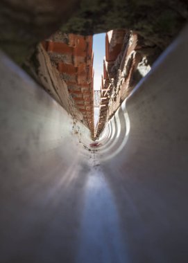 Interior of a PVC gutter at the confluence of a gable roof. tunnel vision clipart