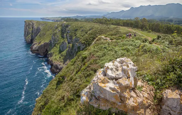 stock image Family group observing the Cliffs of Hell, Ribadesella Eastern Asturias, Spain