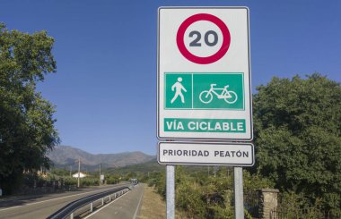 Hervas, Spain - 24th, Jul, 2024: Segregated cycle lane running parallel to a local road. Traffic sign limiting traffic to cyclists and pedestrians clipart