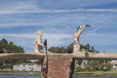 Ribadesella, Spain - July 13th, 2024: Monument to paddlers,  made by Pachu Muniz in 2007 clipart