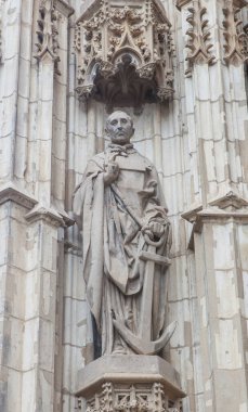 Seville, Spain - Sept 26th, 2024: Clement of Rome Martyr statue. Main Door of Seville Cathedral, Spain clipart