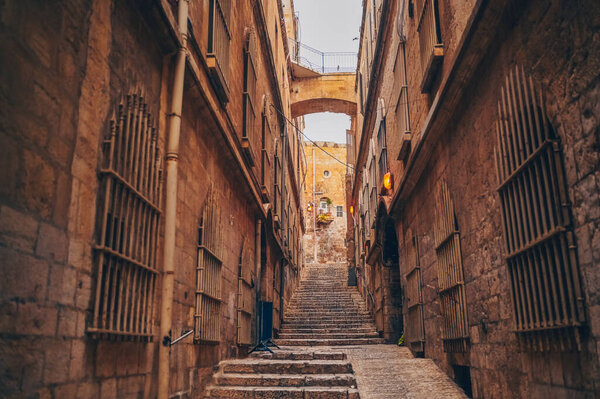 Cozy narrow small Street in the Old City of Jerusalem, Israel. Typical stoned houses and walls of jewish historic quarter area part.