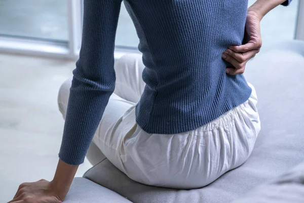 Woman Suffering Back Ache Sofa Female Back Pain Home Stock Image