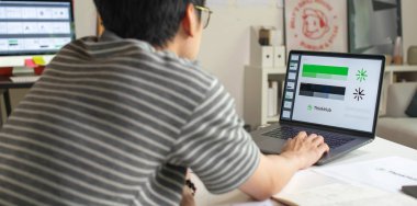 Male Asian graphic designer working in an office studio, designing logos and showcasing the corporate identity and logo design process.	