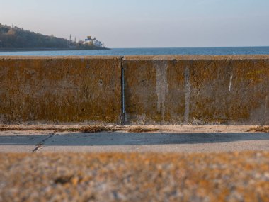 Ufukta hidroelektrik santrali bulunan Kyiv deniz ve tepesinin sakin mavi suları üzerinde eski beton bloklar bulunan gezinti güvertesinden görüş..