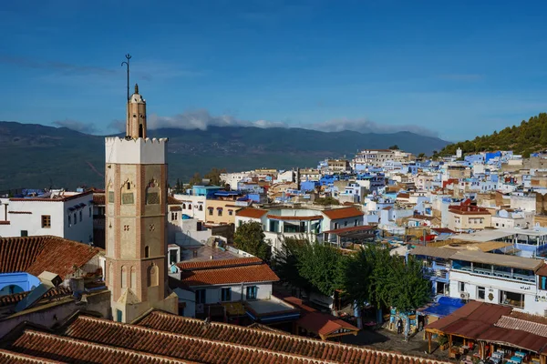 North Africa. Morocco. Chefchaouen. The minaret of the Grand Mosque of Chefchaouen and the colored houses in a background