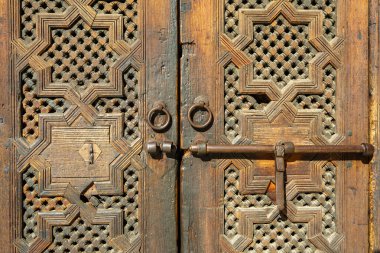 Morocco. Fez. Medersa Bou Inania built between 1350 and 1355 for Sultan Abou 'Inan Faris under the Merinid dynasty. Wood door marquetry detail.