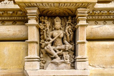 India. Madhya Pradesh state. The Khajuraho Group of Monuments are a group of Hindu and Jain temples. Bas relief at Parshvanatha Jain temple clipart