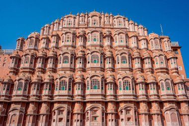 India. Rajasthan. Jaipur (The pink city). Hawa Mahal. (Palace of the Winds). General view of the facade under a blue sky clipart