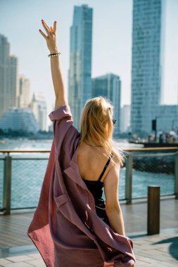 Happy woman tourist admiring the skyline of Dubai