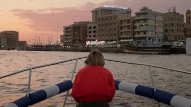 Yacht cruising at Dubai Creek at sunset. Editorial taken 2 January 2023, Dubai, UAE