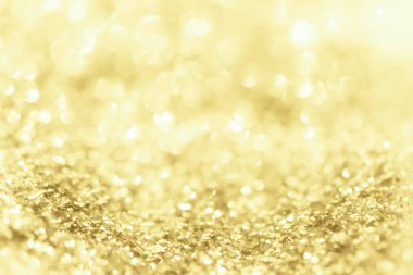 Altın ışıklı Noel arkaplanı. Soyut ışıltılı parlak arkaplan Bokeh odaklı altın ışıklarla