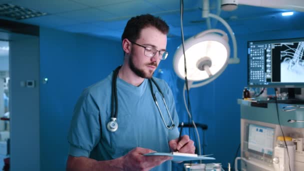 Veterinarian Stethoscope Writing Something Looking Camera Smile Dark Blue Lit — Stock Video