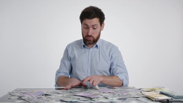 Man Blue Shirt Shifting Some Bills Money Pile Table Looks — Stock Video