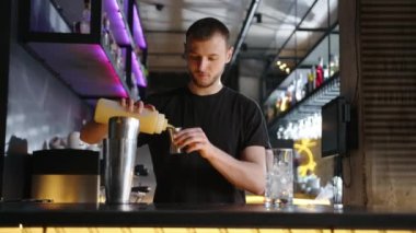 Barmen bar tezgahında alkollü kokteyl hazırlıyor. Yüksek kalite 4k görüntü