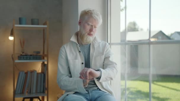 Sad Young Bearded Albino Man Sitting Window Windowsill Waiting Someone — Stock Video