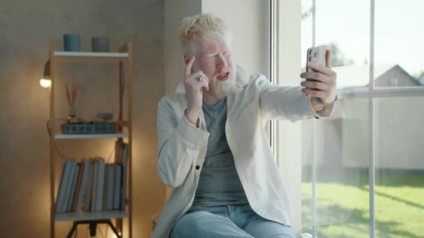 Upset Young Albino Man Speaking Cell Phone Video Link Sitting — Stock Video