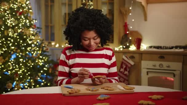 Young Black Woman Painting Handmade Cookies Pink Using Tube Food — Stock Video