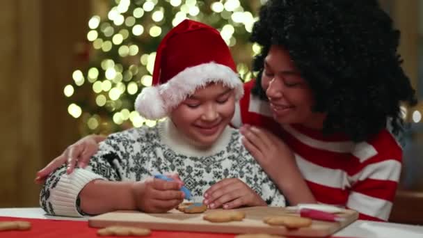 Middle Aged Mother Helping Year Old Sun Paint Gingerbread Cookie — Stock Video
