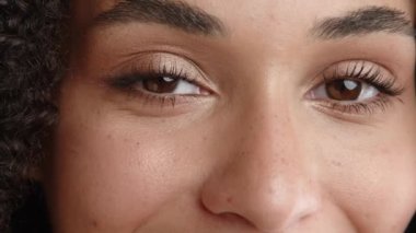 Çekici bir kadın yüzü, sağlıklı bronzlaşmış bir ten, geniş siyah kaşlar, ince maskara tabakalı güzel gözler ve karga ayaklar. Yüksek kalite 4k görüntü