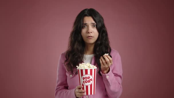 Young Girl Very Upset While Watching Movie She Eating Popcorn — Stock Video