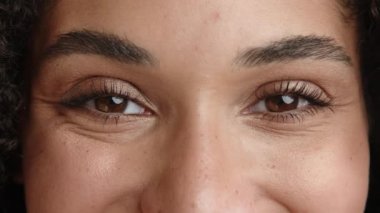 Kırpılmış manzara, nazik görünüşlü melez bayan, olumlu duygular, uzun kirpikli ela gözler, bronzlaşmış ten, gülümserken kırışıklıklar. Yüksek kalite 4k görüntü