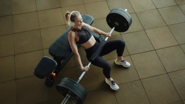 Beautiful Blonde Headphones Performs Hip Thrust Exercise Dressed Black Sportswear — Stock Video