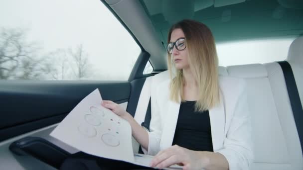 Businesswoman Glasses White Jacket Works Documents Charts Back Seat Prestigious — Stock Video