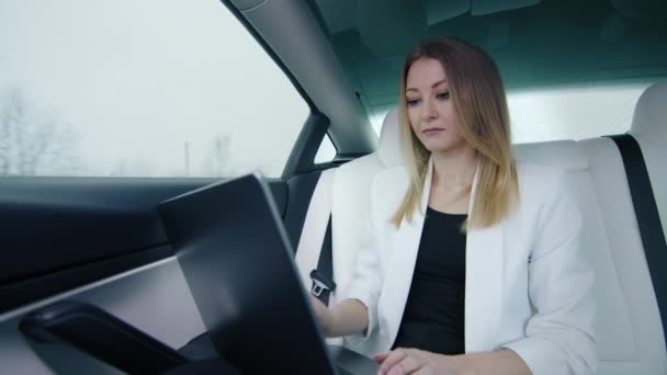在通勤途中在笔记本电脑上工作的女商人完成了工作 关上了笔记本电脑的盖子 平静地从车窗向外望去 外面的天气很凄凉 高质量的4K镜头 — 图库视频影像
