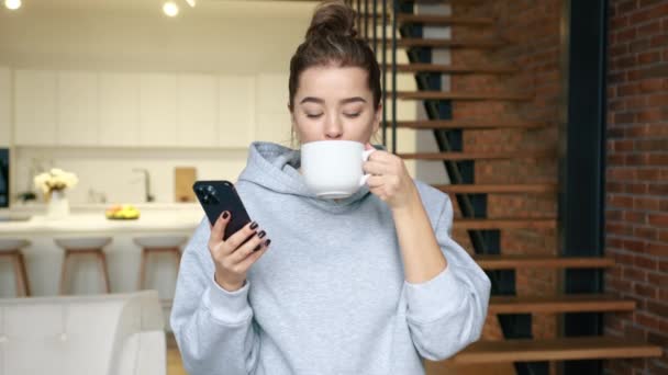 Mujer Joven Disfruta Una Taza Café Mientras Envía Mensajes Texto — Vídeos de Stock
