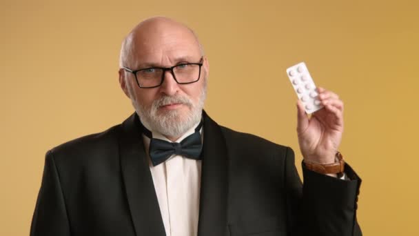 Anciano Atractivo Sostiene Una Tira Píldoras Medicamentosas Mano Indicando Edad — Vídeos de Stock