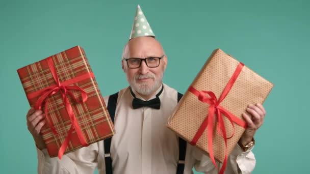 Cheerful Elderly Man Festive Cap His Head Presents Two Beautiful — Stock Video