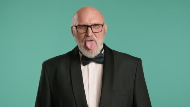 Playful Senior Man Classic Tuxedo Makes Funny Face Sticking Out — Stock Video