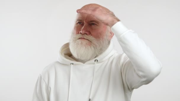 Video Captures Puzzled Elderly Man White Hoodie Placing His Hand — Stock Video