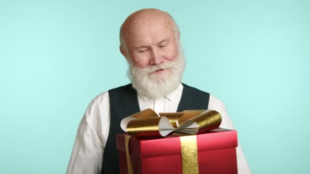 Captured Tender Moment Senior Gentleman Cradles Large Festively Adorned Gift — Stock Video