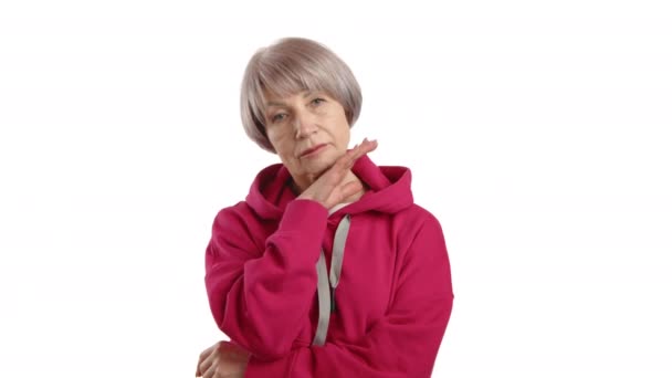Elderly Lady Vibrant Pink Hoodie Gently Fixing Her Collar Looking — Stock Video
