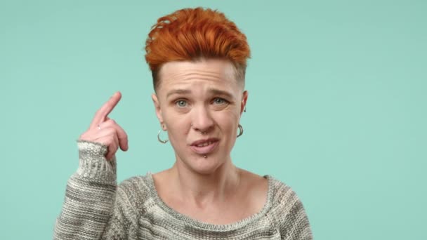Individual Vibrant Orange Hairstyle Twirls Finger Temple Playfully Suggesting Someone — Stock Video