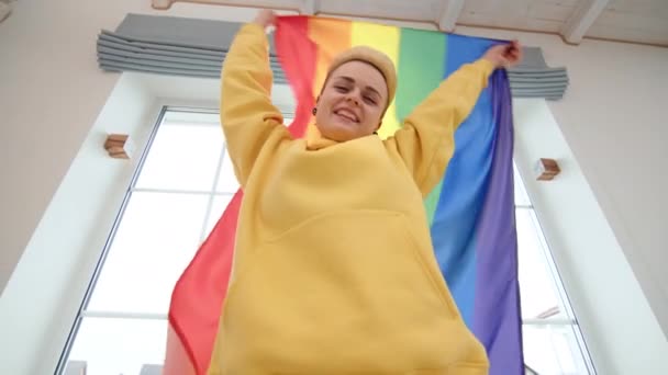 Girl Vibrant Yellow Hoodie Stands Her Home Triumphantly Lifting Lgbt — Stock Video