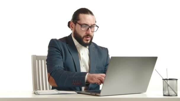 Focused Businessman Suit Jotting Notes Notebook Laptop White Desk Symbolizing — Stock Video
