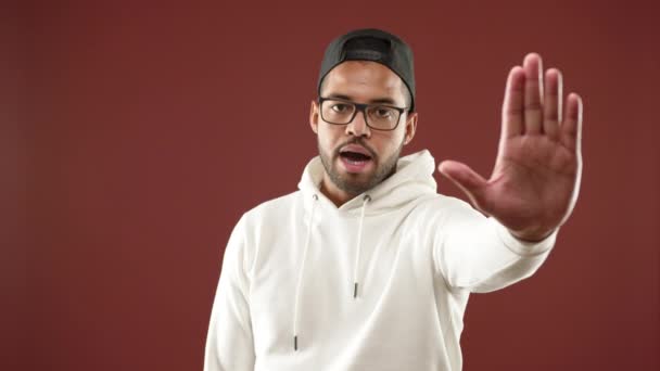 Man Wearing Cap White Hoodie Makes Commanding Stop Gesture His — Stock Video