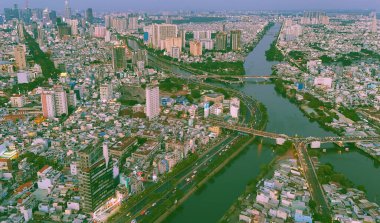 Ho Chi Minh 'in insansız hava aracı görüntüsü, kalabalık evleri olan büyük Asya şehri, Nhieu Loc Thi Nghe kanalı, Y köprüsü suyu, yoldaki araç trafiği, 4. seviye gecekondu mahallesi