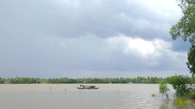 Bulutlu bir günde Mekong Deltası manzarası, yağmura hazır, suda balıkçı teknesi, Ben Tre, Vietnam 'da nehirde ördek sürüsü