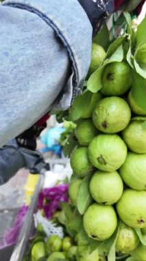 Ho Chi Minh caddesindeki Vietnamlı satıcı, motosiklette göz alıcı taze guava meyveleri, seyyar araba satışı müşteriler için temiz gıda, küçük işletmeler için kazanç