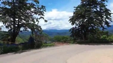 Motosikletle yolculuk, yüksek hızda hareket ettiğinde motorsiklet görüş alanından dönen dağlık arazi düşünce ormanı eğrisinde hareketli bir yolculuk yapar.