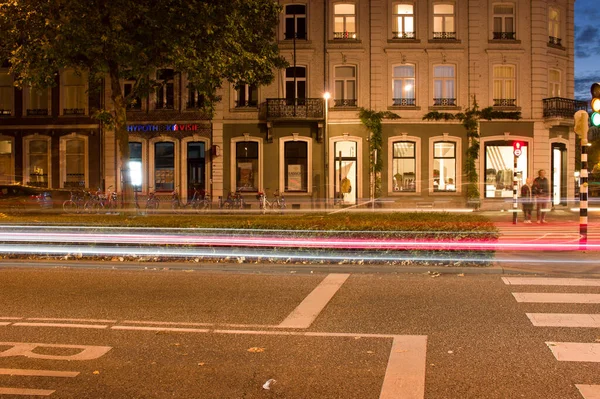 stock image Maastricht, Netherlands - October 12, 2022: Road at night with traffic blurred by motion in the center of Maastricht