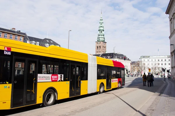 stock image Copenhagen, Denmark - April 9, 2023: Yellow and red city bus in the center of Copenhagen