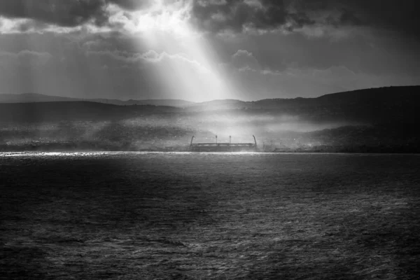 Сценический Вид Солнечного Света Струящийся Морю Против Силуэта Горного Хребта — стоковое фото