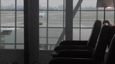 airport interior with a window and a glass of water